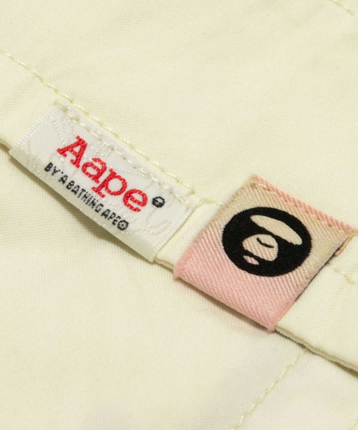 에이프(AAPE) AAPEUNVS 문페이스 팬츠 아이보리 / AAPPTMD610XXQIVA