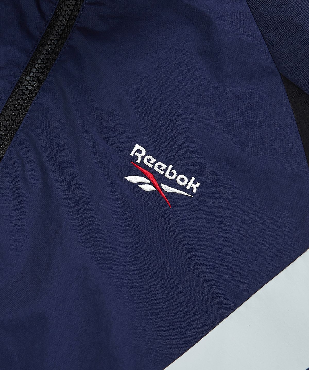 리복(REEBOK) DNA 트랙 윈드 브레이커 - 네이비