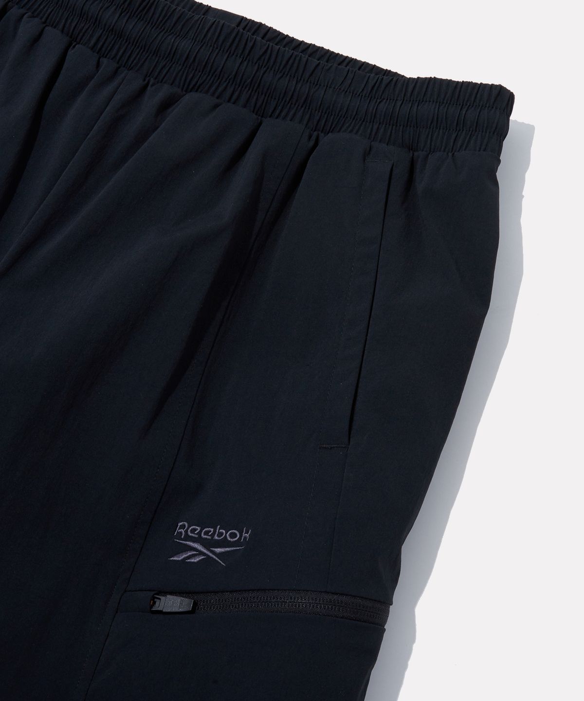 리복(REEBOK) 올커버 스트레치 2WAY 팬츠 - 블랙