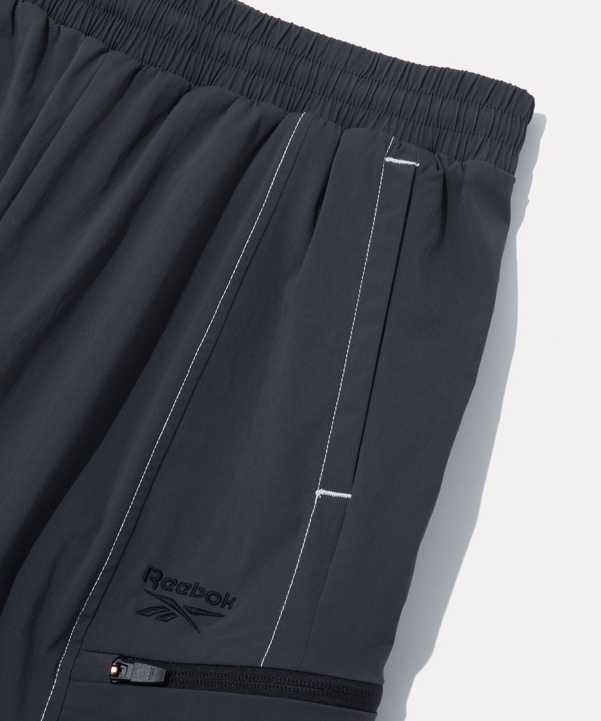 리복(REEBOK) 올커버 스트레치 2WAY 팬츠 - 차콜