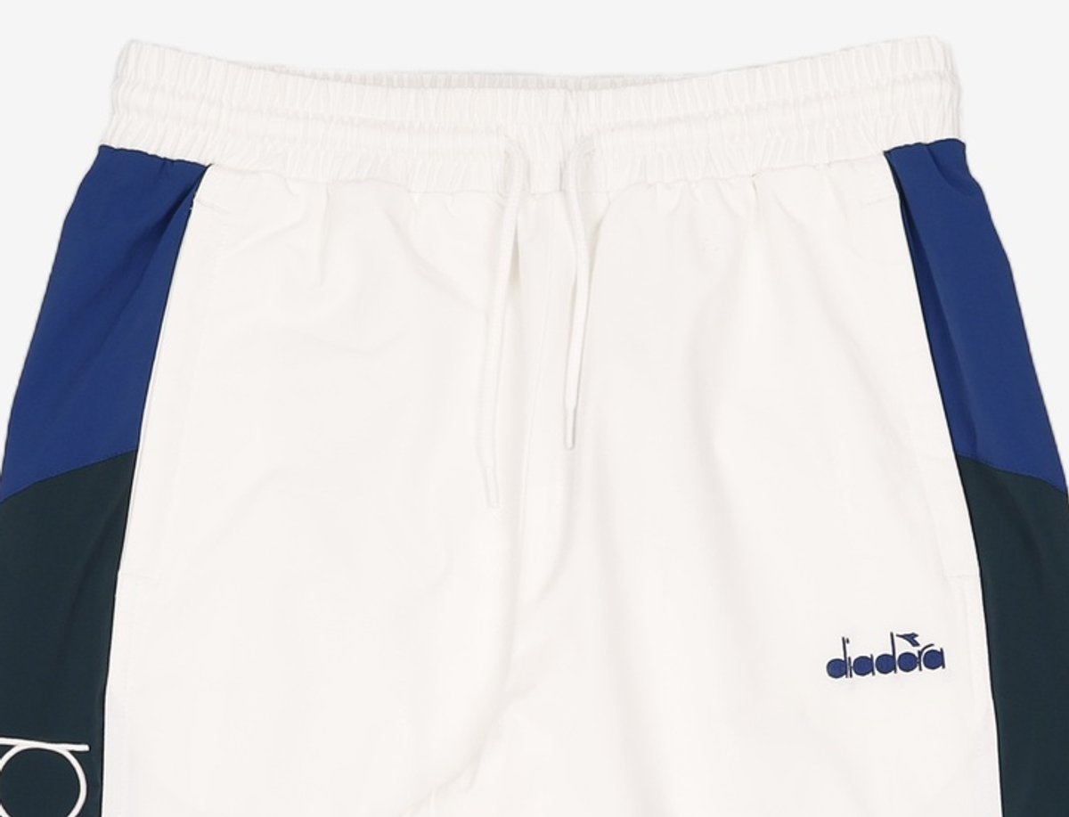 디아도라(diadora) 몬텔로 컬러블럭 우븐 팬츠 OFF WHITE 85