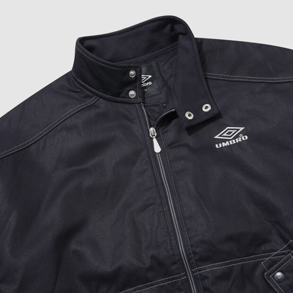 엄브로(UMBRO) 크리스피 타슬란 스탠넥 패딩 자켓 네이비 UR321CPJ91