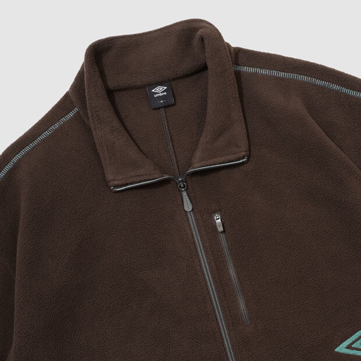 엄브로(UMBRO) 크리스피 타슬란 플리스 자켓 브라운 UR324CFJ91