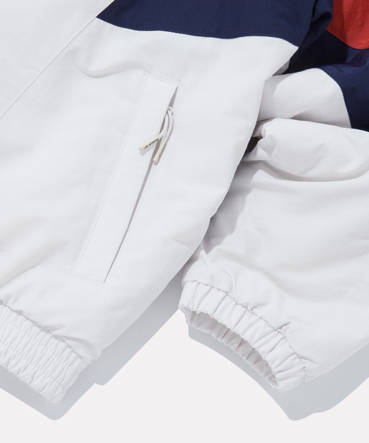리복(REEBOK) DNA 트랙 패딩 자켓 - 페일 베이지