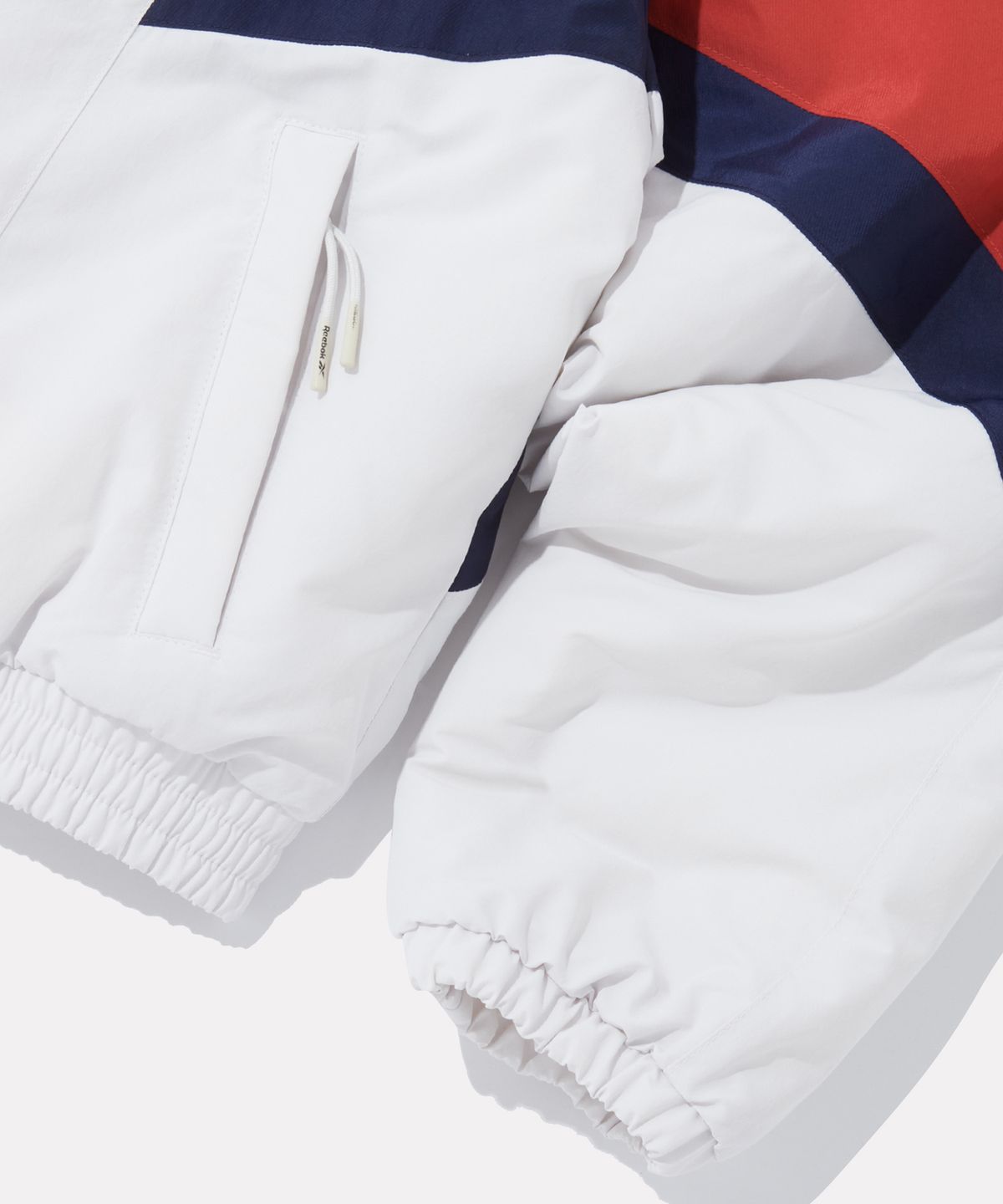 리복(REEBOK) DNA 트랙 패딩 자켓 (W) - 페일 베이지