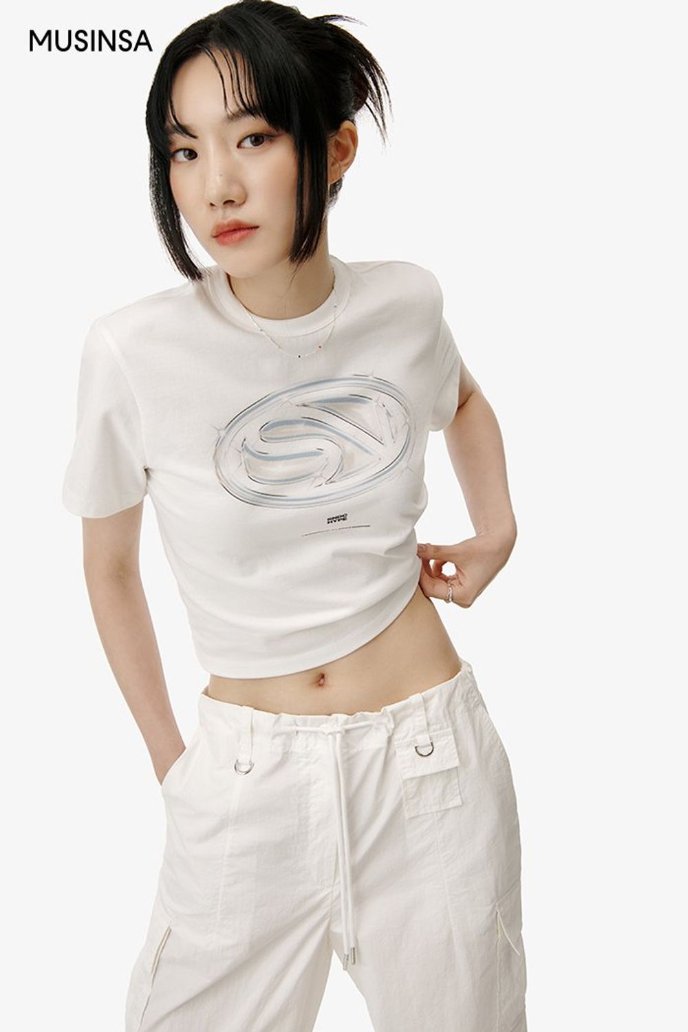 그래픽이 돋보이는 티셔츠와 카고 팬츠를 함께 입고 실버 컬러 미니 백으로 포인트를 더한 캐주얼 룩 #심볼 #와이드핏 #올화이트 #메탈릭 #크롭 #여름 #캐주얼 #실버백 #에디터_이민영